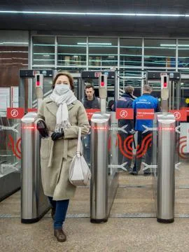 Passengers pass through automatic turnstiles at the Moscow metro station. Stock Photos