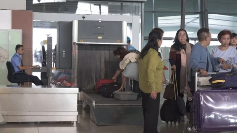 Passengers passing security check point at Jakarta International Airport Stock Footage 114740179