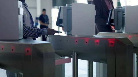 Passengers passing through automatic gates at airport terminal. Media Stock Footage 315480285