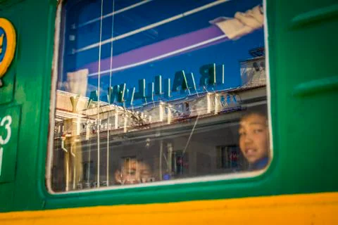 Passengers on a passing train Stock Photos