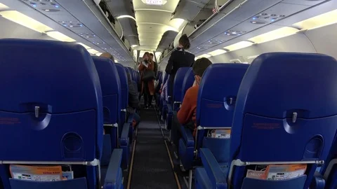 Passengers on the plane take their places on Aeroflot flight Stock Footage 74364239