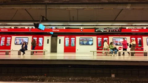 Passengers on platform as red and white metro train departing from station in Stock Footage 336901984