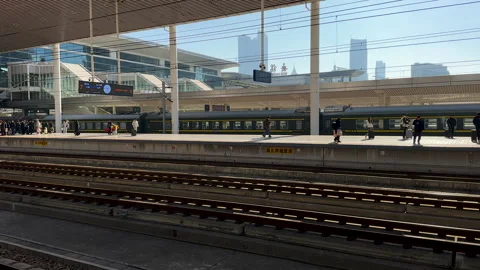 Passengers, platforms and rail tracts in Wuxi Railway Station Stock Footage 296645182