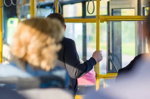 Passengers prepare for exit in interior of modern bus Stock-Fotos