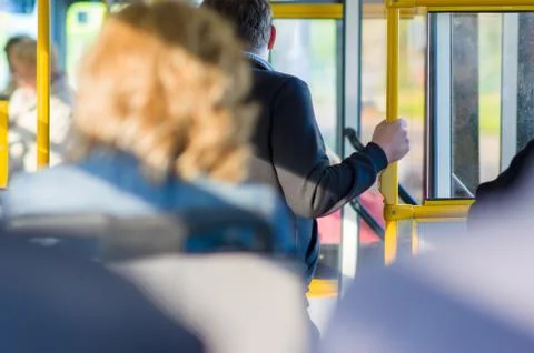 Passengers prepare for exit in interior of modern bus Stock Photos