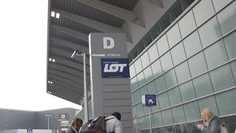 Passengers preparing boarding under LOT airlines sign in Warsaw airport, Poland Stock Footage 124871869
