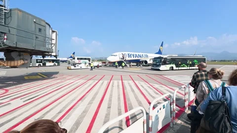 Passengers Queue at Airport Apron Boarding Ryanair Aircraft Under Clear Blue Sky Stock Footage 335958109