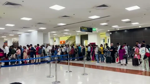 Passengers queue at the airport to board a flight during peak hours. 4K Stock Footage 242765086