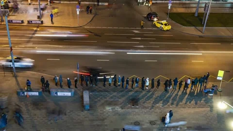 Passengers in the queue for boarding the bus on a busy street at the end of t Stock Footage 144223161