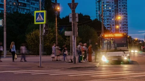 Passengers in the queue for boarding the bus on a busy street at the end of t Stock Footage 157984802