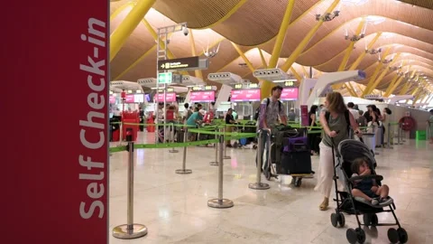 Passengers Queue at Iberia Check-in Desks and Self-check-in Machines at Madrid Stock Footage 305220540