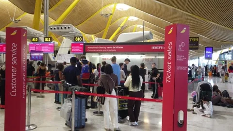 Passengers Queue at Iberia Customer Service Desk in Madrid Barajas Airport Stock Footage 339047203