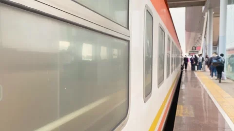 Passengers queue on platform beside modern train, commuting travel concept,.. Stock Footage 329680798