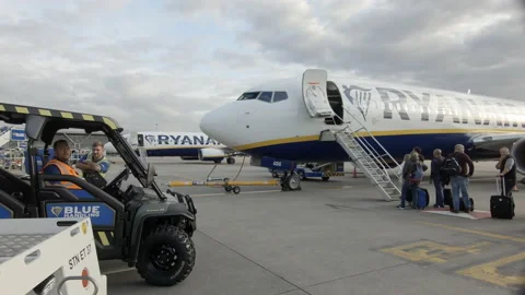 Passengers queue waiting to board Ryanair airplane. London Stansted Airport 4K Video stock 130314882