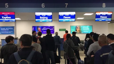 Passengers queueing for check-in at an international airport Stock Footage 341997340