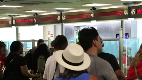 Passengers queuing for processing at passport control at international airport Stock Footage 295113351