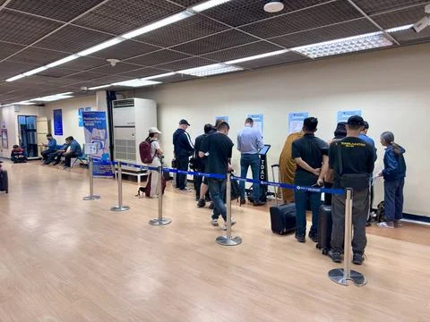 Passengers queuing to use the TDAC electronic digital arrival card Stock Photos