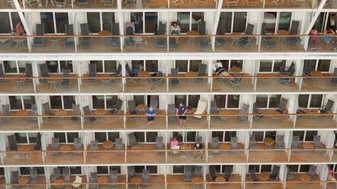 Passengers relaxing on private balconies of multi-deck cruise ship exterior. Vídeos de archivo 341990343