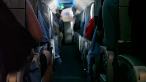 Passengers ride on bumpy commercial airline in their seats Stock Footage 77187647