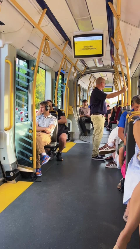 Passengers ride inside a modern public tram in Warsaw, Poland.  動画素材 345254477
