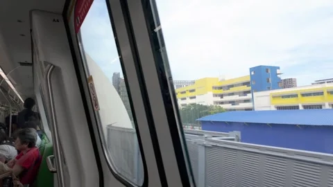 Passengers ride on a Singapore MRT train Stock Footage 340933356