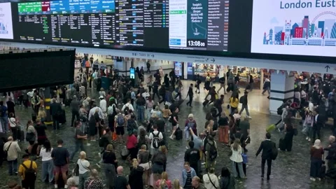 Passengers rushing through Euston Station in London to catch their train Stock Footage 316749591
