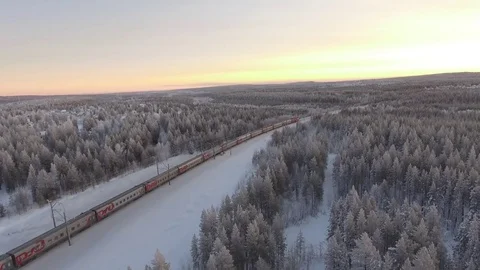 Passengers rzd Train ride in forest winter snow north. Polar express aerial 4k  Stock Footage