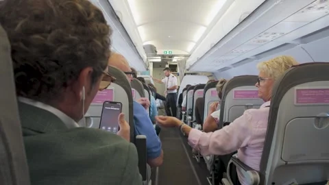 Passengers seated inside airplane cabin before takeoff during flight prepar.. Stock Footage 325108297