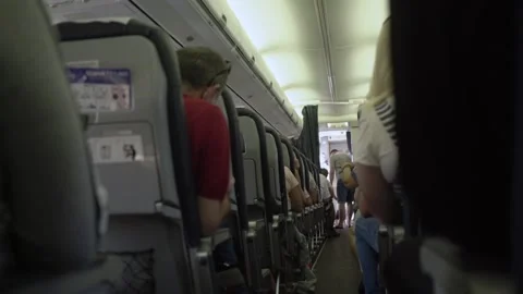 Passengers in seats in cabin of air plane during flight in coronavirus pandemic Stock Footage 148984227