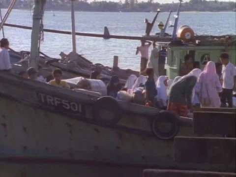 Passengers settling in a boat ready to cross the water body on a sunny day Stock Footage 79883081