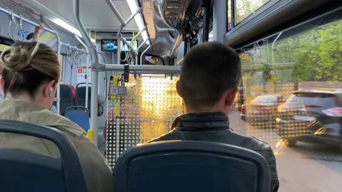 Passengers sit inside public transport. Bus rides through Moscow streets. Stock Footage 196203024