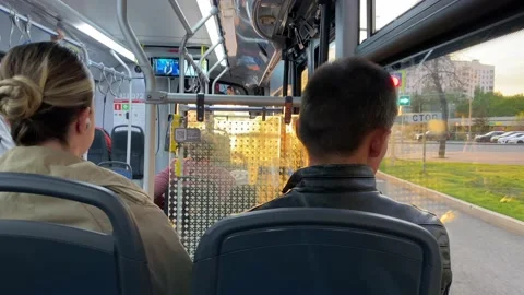 Passengers sit inside public transport. Bus rides through Moscow streets. Stock Footage 196203389