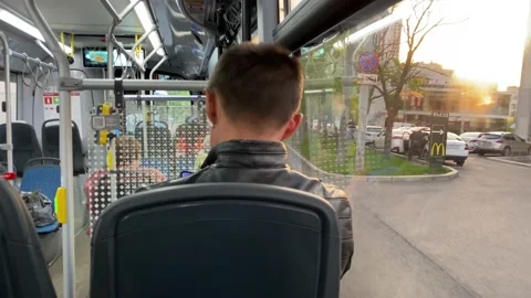 Passengers sit inside public transport. Bus rides through Moscow streets. Stock Footage 196203400