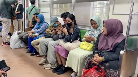 Passengers sitting and standing inside the train carriage. Stock Footage 283973186