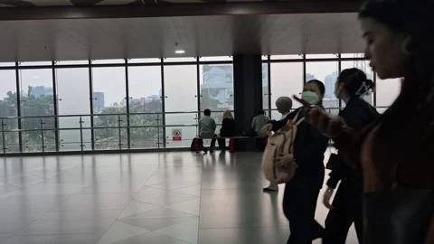 Passengers sitting and walking inside Tanah Abang train station Stock Footage 343962460