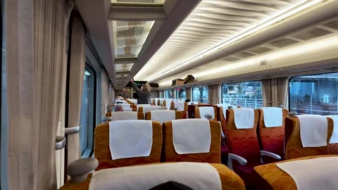 Passengers sitting on comfortable seats inside HC85 series train in Toyama Video stock 309205347