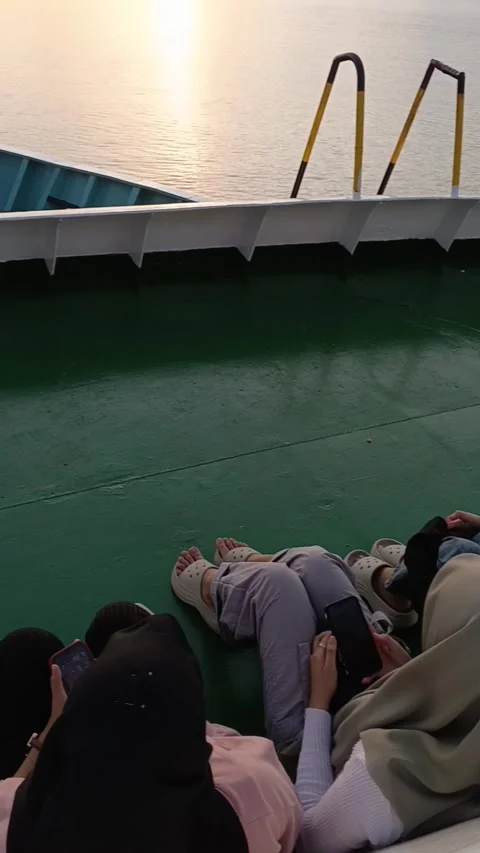 Passengers sitting on the ferry deck while seeing sunset Stock Footage 280986433