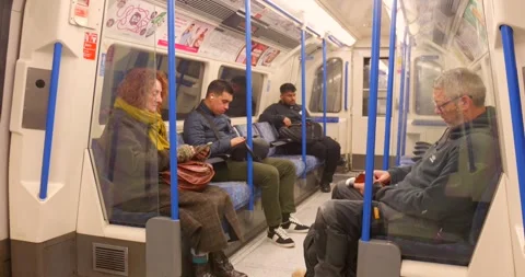 Passengers sitting inside London Underground train 動画素材 323384196