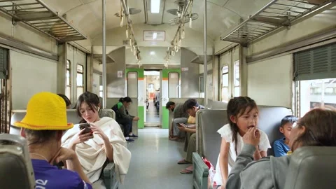 Passengers Sitting Inside Old Commuter Train Carriage in Bangkok 動画素材 323350350