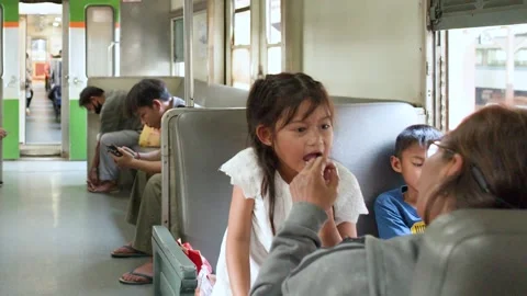 Passengers Sitting Inside Old Commuter Train Carriage in Bangkok 動画素材 323780448