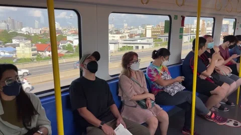 Passengers sitting on moving train. Cityscape view and car movings on road Stock Footage 183548452