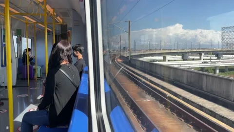 Passengers sitting on moving train. Cityscape with empty billboard daytime Stock Footage 183549782