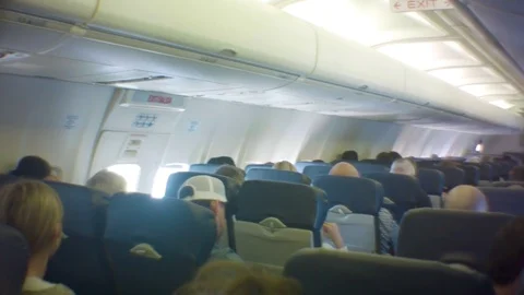 Passengers sitting on plane waiting Stock Footage 76589796