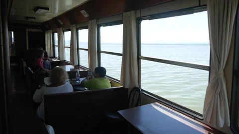 Passengers Sitting in the Restaurant of the Ship Sailing on the Lake Stock Footage 244815762