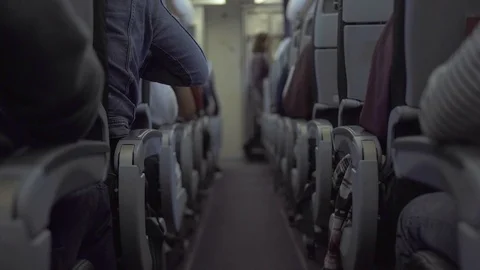 Passengers sitting on seat airplane while flying in sky. Passengers inside cabin Stock Footage 105052914