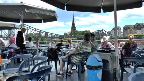Passengers Sitting at Tables on Top Deck of Cruise Boat in Frankfurt Stock Footage 83050827