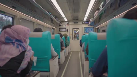 Passengers sitting in the train seats. Relaxing and enjoying the journey. Stock Footage 248779197