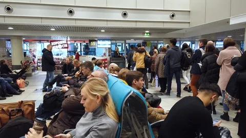 Passengers stand in line for boarding a flight. Waiting room at the airport. Video stock 128950701