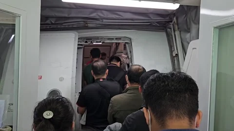 Passengers standing in a queue while boarding an airplane through the door. Stock Footage 324318820