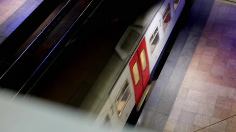 Passengers stepping on commuter train at night in train station Stockbeeldmateriaal 223139575